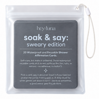 Clear hanging pouch of Hey Luna 'soak & say' shower affirmation cards, black labeled 'sweary edition', shown on a white background.