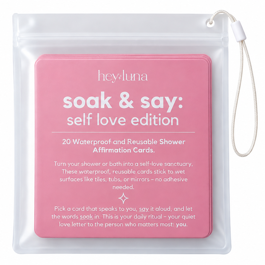 Clear hanging pouch of Hey Luna 'soak & say' shower affirmation cards, pink labeled 'self love edition', shown on a white background.